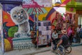 Male tourist in wheelchair looking at a mural of a cute llama on the street at Mercado de Las Brujas in La Paz, Bolivia