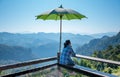 Male tourists Sitting on wooden balcony Which has a large umbrella shading the sun,