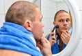 Male with towel shaving