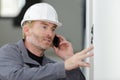 male tradesman making telephone call