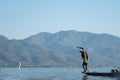 A male tradiotional fisherman with his net on a wooden boat Royalty Free Stock Photo