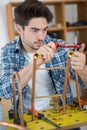 Male trainee plumber studying pipework Royalty Free Stock Photo