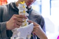 Male trainer explaining about spinal column to female athletic in fitness center