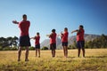 Male trainer instructing kids while exercising in the boot camp Royalty Free Stock Photo