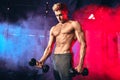 Male trainer with muscular torso holding dumbbells in hands at cross fit gym Royalty Free Stock Photo