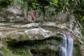 A male traveler admires waterfalls on the Agura River in Sochi