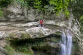 A male traveler admires waterfalls on the Agura River in Sochi Royalty Free Stock Photo