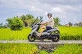 Male traveler on a bike among a rice field. Tourist travels to Bali Royalty Free Stock Photo