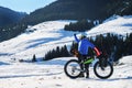 Male traveler on a fatbike in winter in the mountains