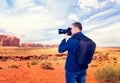 Male traveler photographing mountain valley