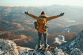 A male traveler with raised hands standing stands on the top of a mountain with white fog below. Royalty Free Stock Photo