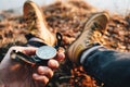 Male traveler rest on nature and hold compass in hand and search way. POV view. Blurred background Royalty Free Stock Photo