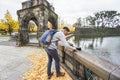 Male traveler set camera for taking photographs in Tokyo, Japan in autumn with changed color leaves