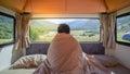 Male traveler staying in the blanket in camper van Royalty Free Stock Photo