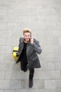 Male traveler walking with mobile phone and bag