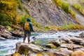 Male traveller with backpack standing on a forest river landscape Royalty Free Stock Photo