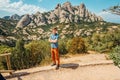 A male traveller enjoys views from the mountains of Montserrat in Spain
