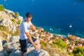 Male traveller looking at the panorama of Dubrovnik and sea.