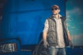 Male Trucker Standing In Front Of Big Rig