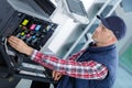 Male trying to repair office printer Royalty Free Stock Photo