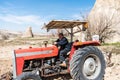 A male Turkish farmer driving a tractor with thumbs up in the town of Goreme, Cappadocia, a historical region of Turkey