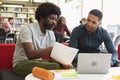 Male University Student Working In Library With Tutor Royalty Free Stock Photo