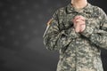 Male in US Army soldier uniform praying