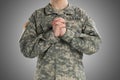 Male in US Army soldier uniform praying