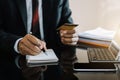 Male use credit card and take notes in the notebook at the office desk in the morning Royalty Free Stock Photo