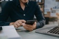 Male use their phones and computers to work in the morning Royalty Free Stock Photo