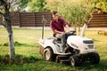 male using lawmower for landscaping works. Motorised agriculture concept