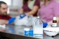 A male veterinarian anesthesiologist makes the procedure for a cat - a catheterization of the bladder. The assistants are holding