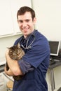 Male Veterinary Surgeon Holding Cat In Surgery