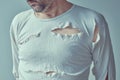 Male victim of domestic violence and abuse, conceptual image of adult man with torn shirt