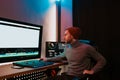 Male Video Editor Working on His Personal Computer with Big blank Display Royalty Free Stock Photo