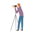 Male Video Operator Looking Through Camcorder on Tripod, Videographer with Professional Camera, Film Scene or Video Blog Royalty Free Stock Photo