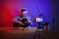 Male vlogger recording music related broadcast at studio Royalty Free Stock Photo