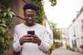 Male Vlogger Or Social Influencer In City Using Mobile Phone On Street To Post To Social Media