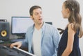 Male vocal coach teaching little girl how to sing. Royalty Free Stock Photo