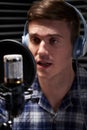 Male Voice Over Artist In Recording Studio Talking Into Microphone