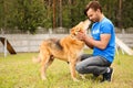 Male volunteer with homeless dog at animal shelter