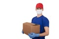 A male volunteer in a medical mask and rubber gloves holds a box. Social help. Delivery of goods by courier. Copy spaes
