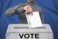 Male voter drops a blank ballot in a transparent ballot box, concept of state elections, referendum