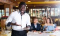 Male waiter demonstrating his upset with little tips from restaurant visitors