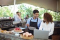 Male waiter and female waitress with laptop Royalty Free Stock Photo