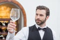Male Waiter Holding Wine Glass In The Restaurant