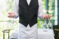 Male Waiter Holding Wine Glasses In The Restaurant