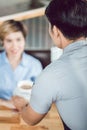 Male waiter serving coffee to female customer Royalty Free Stock Photo