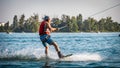 Male wakeboarder being pulled on a lake