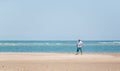 Male walking along the Crystal Coast under the clear sky in North Carolina